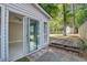 View from the back of the property highlighting a sliding glass door and an aged wood deck at 414 Courtland Dr, Summerville, SC 29486