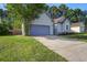 Single story home with a long driveway, a blue garage door, and well-manicured lawn at 414 Courtland Dr, Summerville, SC 29486