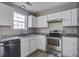 Bright kitchen with stainless steel appliances, white cabinets, and durable countertops at 414 Courtland Dr, Summerville, SC 29486