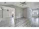 Inviting living room with gray walls, modern light fixture, updated gray flooring, and a view of the front entryway at 414 Courtland Dr, Summerville, SC 29486