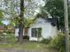 Exterior view of a house in disrepair, with boarded-up windows at 4232 Grimke St, North Charleston, SC 29405
