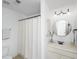 Well-lit bathroom with a neutral color palette, and a shower with a curtain at 4906 W Liberty Park Cir, North Charleston, SC 29405