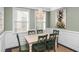 Charming dining room with a rustic wooden table, green chairs, and an elegant beaded chandelier at 4906 W Liberty Park Cir, North Charleston, SC 29405