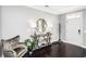 Bright foyer with modern decor, including a round mirror, stylish table, and an inviting armchair at 4906 W Liberty Park Cir, North Charleston, SC 29405