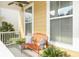 Inviting front porch with comfortable seating, decorative pillows, and potted plants for a cozy outdoor space at 4906 W Liberty Park Cir, North Charleston, SC 29405
