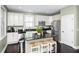 Modern kitchen with white cabinets, stainless steel appliances, and a central island with seating at 4906 W Liberty Park Cir, North Charleston, SC 29405