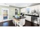 Eat-in kitchen features dark wood floors, granite countertops, an island, and stainless steel appliances at 4906 W Liberty Park Cir, North Charleston, SC 29405