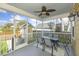 Relax on this screened porch featuring a ceiling fan and a view of the backyard and storage shed at 4906 W Liberty Park Cir, North Charleston, SC 29405