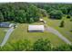 An elevated view of a country property showcasing a metal shop building with ample surrounding outdoor space at 4911 Chisolm Rd, Johns Island, SC 29455