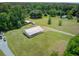 Aerial view of a country property, featuring a large, metal shop building with plenty of outdoor space at 4911 Chisolm Rd, Johns Island, SC 29455