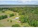 This aerial image features a serene property with large metal shop building and a landscape near the marsh at 4911 Chisolm Rd, Johns Island, SC 29455