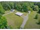 Aerial view of a rural property with outbuildings, featuring a metal shop building and surrounding outdoor space at 4911 Chisolm Rd, Johns Island, SC 29455
