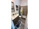 Well-designed bathroom featuring tiled walk-in shower, modern vanity, and gray plank flooring at 4911 Chisolm Rd, Johns Island, SC 29455
