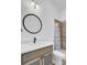 Bathroom featuring a round mirror, white countertops, and a shower with patterned curtain at 4911 Chisolm Rd, Johns Island, SC 29455