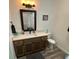 Bathroom with modern vanity, large framed mirror, and a tub shower combination at 4911 Chisolm Rd, Johns Island, SC 29455