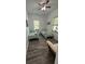 Well-lit bedroom with twin beds, neutral walls, gray plank flooring, and lots of natural light at 4911 Chisolm Rd, Johns Island, SC 29455