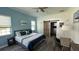 Comfortable bedroom featuring a king-sized bed, desk, ceiling fan, and a barn door to the closet at 4911 Chisolm Rd, Johns Island, SC 29455