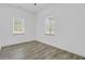 Bedroom with two windows and wood flooring at 4911 Chisolm Rd, Johns Island, SC 29455