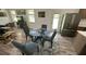 Dining area with glass table, modern chairs, with hardwood floors and stainless refrigerator at 4911 Chisolm Rd, Johns Island, SC 29455