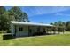 Spacious single-story home with covered porch and ample green lawn and mature tree coverage at 4911 Chisolm Rd, Johns Island, SC 29455