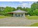 Exterior view of home with a covered porch, gravel driveway and a yard at 4911 Chisolm Rd, Johns Island, SC 29455