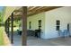 Wide exterior shot with spacious patio with ceiling fan, and barbecue at 4911 Chisolm Rd, Johns Island, SC 29455