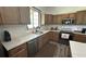 Well-lit kitchen features stainless appliances, quartz countertops and wood-look flooring at 4911 Chisolm Rd, Johns Island, SC 29455