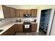 Well-lit kitchen features wood cabinets, modern appliances, and access to the walk-in pantry at 4911 Chisolm Rd, Johns Island, SC 29455