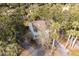 Aerial shot of the stilt home surrounded by lush trees and an attractive driveway at 507 Cobby Creek Ln, Seabrook Island, SC 29455