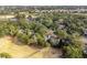 An aerial view shows the lush, green landscape and residential neighborhood near the golf course at 507 Cobby Creek Ln, Seabrook Island, SC 29455