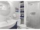 Updated bathroom featuring a vanity, toilet, built-in shelves, and a stylish tiled walk-in shower at 507 Cobby Creek Ln, Seabrook Island, SC 29455
