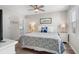 Cozy bedroom with a queen-size bed, ceiling fan, and bright natural light from a window at 507 Cobby Creek Ln, Seabrook Island, SC 29455