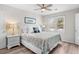 Comfortable bedroom with a bed, nightstands, ceiling fan, and view to the outdoors through the window at 507 Cobby Creek Ln, Seabrook Island, SC 29455