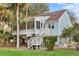 Lovely exterior view of a raised home with light blue siding and mature trees at 507 Cobby Creek Ln, Seabrook Island, SC 29455