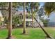 Stilt home with stairs and porch surrounded by large palm trees and a green lawn at 507 Cobby Creek Ln, Seabrook Island, SC 29455