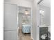 Hallway with stackable washer and dryer, leading to a bathroom sink and view of a bedroom at 507 Cobby Creek Ln, Seabrook Island, SC 29455