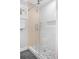 Modern shower with white and wood-look tile, glass door, and rainfall showerhead at 507 Cobby Creek Ln, Seabrook Island, SC 29455
