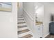 Bright stairway with wood stairs, white risers, handrail, and convenient built-in bar area at 507 Cobby Creek Ln, Seabrook Island, SC 29455