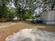 Backyard with grass, trees, garbage and leaves at 5626 Shelton St, North Charleston, SC 29406