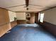 Bedroom with carpet flooring, wood paneling, offering a view to the en-suite bathroom and closet at 5626 Shelton St, North Charleston, SC 29406