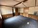 A cozy bedroom with carpet, wood paneling, and natural light from a window, adjacent to the en-suite bathroom at 5626 Shelton St, North Charleston, SC 29406