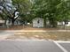 Modest single-Gathering home with mature trees and a chain link fence around the yard at 5626 Shelton St, North Charleston, SC 29406