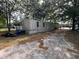 Home exterior surrounded by trees and brown leaves at 5626 Shelton St, North Charleston, SC 29406