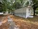 Exterior view of a mobile home featuring a long drive and mature shade trees at 5626 Shelton St, North Charleston, SC 29406