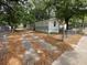 Exterior view of a mobile home featuring a gated drive and mature shade trees at 5626 Shelton St, North Charleston, SC 29406