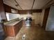 Kitchen with wooden cabinets, stainless steel appliances, and a breakfast bar overlooking the living area at 5626 Shelton St, North Charleston, SC 29406
