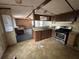 A kitchen featuring wood cabinets, stainless steel appliances, and a tile backsplash, connecting to the living room at 5626 Shelton St, North Charleston, SC 29406