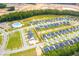 Aerial view of a new construction neighborhood featuring modern homes, community pool, and green spaces at 575 Red Monarch Way, Moncks Corner, SC 29461