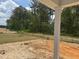 Backyard featuring surrounding trees and a partially installed lawn with freshly tilled topsoil at 575 Red Monarch Way, Moncks Corner, SC 29461