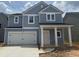 Charming two-story home with blue siding, white trim, and a spacious two-car garage at 575 Red Monarch Way, Moncks Corner, SC 29461